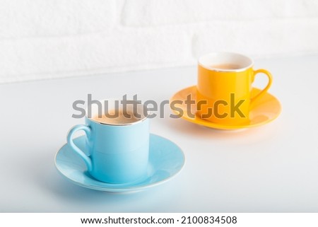 Colorful cups of Turkish coffee view over white studio. Minimal style with copy space.