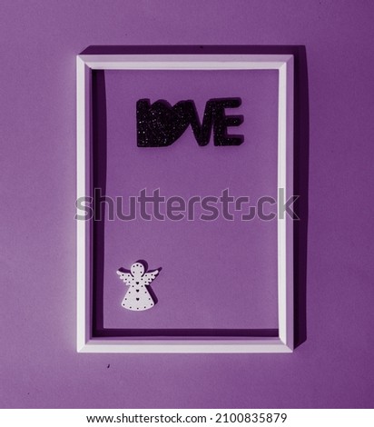 Angel of love in white thin frame on a purple background