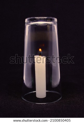 Science experiment: candle going out due to low oxygen in the glass Royalty-Free Stock Photo #2100850405