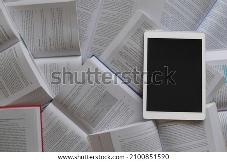 Tablet PC, Tablet pc on the chaos of opened books or many papers. Selective Focus. 