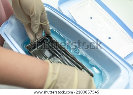 Hands are cleaning medical instruments. Disinfection of a dental instrument. Dental office Royalty-Free Stock Photo #2100857545