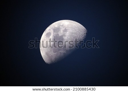 View of the Moon Glowing On Black Background.