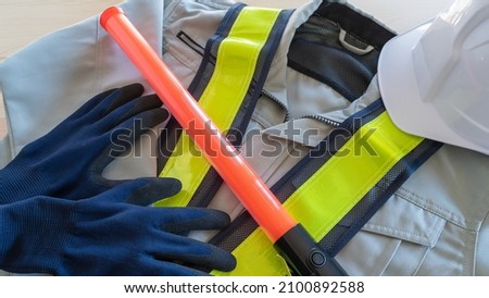 Red stick and security guard uniform.