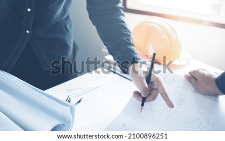 Architect working on blueprint with copy space. Architects workplace - architectural project, blueprints, ruler, calculator. Construction concept. Blue print is fake only for stock photo.