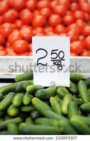 Fresh assorted vegetables (cucumbers and tomatoes) at farmers market 