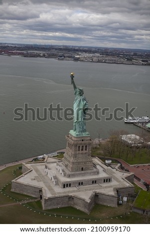 An aerial view of New York cityscape with the famous Brooklyn Bridge and the Statue of Liberty, USA