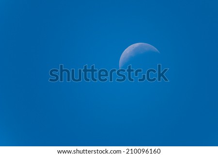 waning moon in a daytime sky