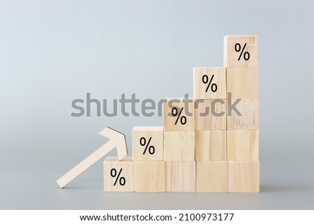 Wooden cubes with percentage symbol over grey background