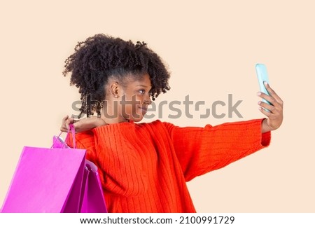 afro american woman shopping with credit card and bags with smartphone