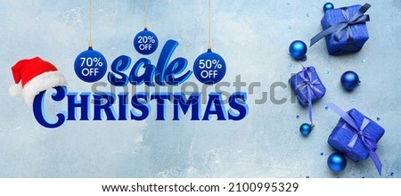 Gift boxes on blue background. Christmas sale