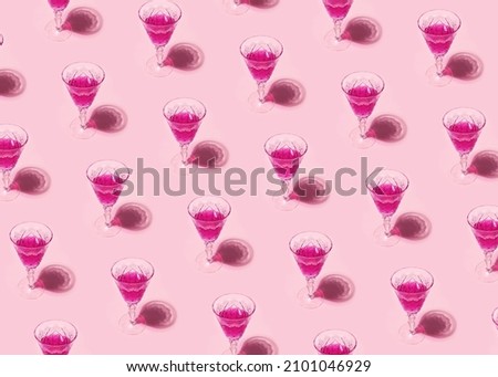 Pink cocktail alcohol drink in a wine glass on pastel pink background. Isometric seamless romantic party pattern. Valentines day minimal concept wallpaper.