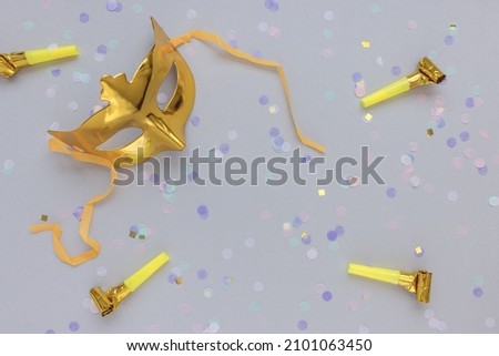 Gold carnival mask on gray background. Carnival season, celebration, costume party concept
