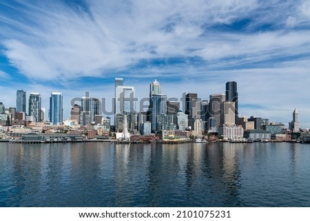 Waterfront Seattle skyline with Great wheel view. Skyscrapers of financial downtown at day time, Washington, USA. A vibrant business neighborhood