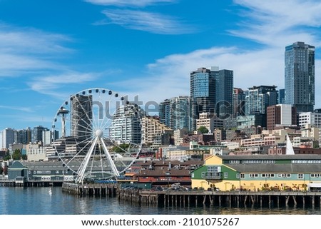 Waterfront Seattle skyline with Great wheel view. Skyscrapers of financial downtown at day time, Washington, USA. A vibrant business neighborhood