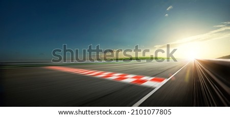 Evening scene asphalt international race track with starting or end line, digital imaging recomposition background. Royalty-Free Stock Photo #2101077805