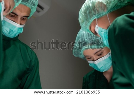 professional surgeon doctor team are working for surgery in medical operating room at hospital