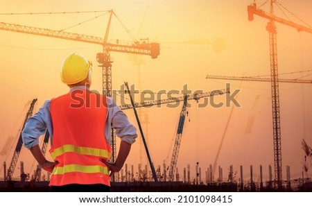 Surveyor Large building Engineer technician  Business Team discuss plan at new construction site. . High ground heavy industry and safety concept.