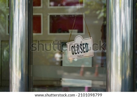A closed sign hanging on a shop door                              