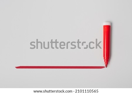 Red highlighter pen and a hand drawn red line, isolated on gray background, template with space for text Royalty-Free Stock Photo #2101110565