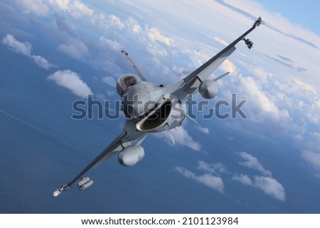F-16 aircraft during an air-to-air photoshoot over Poland. These F-16s are fully armed with 'live' missiles Royalty-Free Stock Photo #2101123984