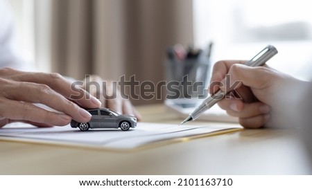 Dealer or manager gives the car to the customers who sign the car purchase documents with insurance, Signing a contract to buy a car that is legal, Document signing and credit approval Concept.