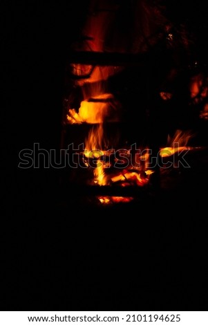 Orange-red fire flame at black night