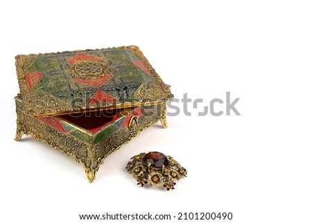 Old jewelry box and vintage brooch on a white background