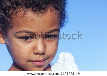 Close-up of a 3 year old girl with a curious look on her face