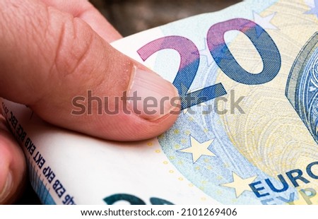Hand holds eouro paper money. Macro photo