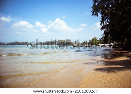Exotic beach in Thailand with stones and palm trees