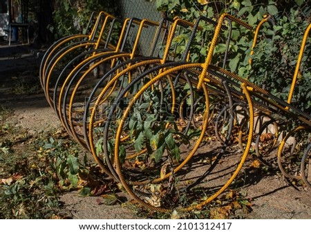 A closeup shot of old, metal bicycle racks in a park