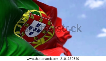 Detail of the national flag of Portugal waving in the wind on a clear day. Democracy and politics. European country. Selective focus Royalty-Free Stock Photo #2101330840