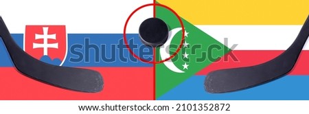 Top view hockey puck with Slovakia vs. Comoros command with the sticks on the flag. Concept hockey competitions