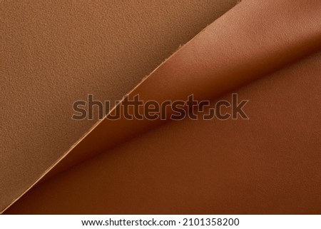 brown artificial leather with waves and folds on PVC base Royalty-Free Stock Photo #2101358200