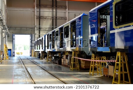 Rail car assembly plant. Industrial workshop for the production of high speed trains. Factory of the manufacturing trainsets rolling stock. Plant for construction and production of passenger train. Royalty-Free Stock Photo #2101376722