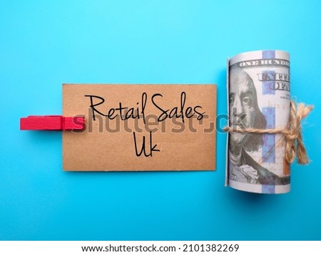 A top view of Banknotes and brown card written with text Retail Sales Uk, Business concept