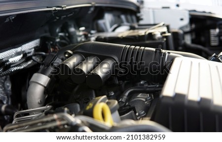 The engine of a modern car. A close-up view of a portion of the intake manifold. Selected focus, background blurred. Royalty-Free Stock Photo #2101382959