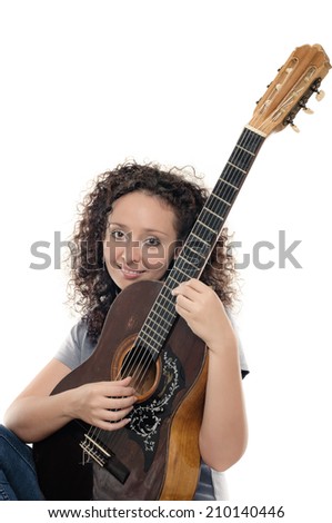 Young beautiful curly woman in casual playing guitar on white