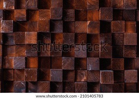 Rough textured volumetric surface of an old retro vintage wall made of square blocks of wood of different sizes. Background or graphic resource for design