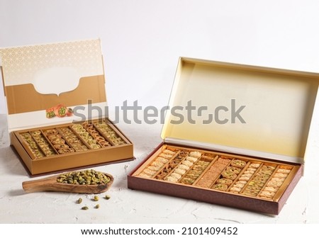 Arabic Sweets or Desserts arabic baklava
Middle East and Arabic desserts, Ramadan sweets (konafa and Baklava) decorated in a gift box
 Royalty-Free Stock Photo #2101409452
