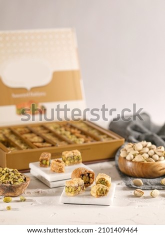 Arabic Sweets or Desserts arabic baklava
Middle East and Arabic desserts, Ramadan sweets (konafa and Baklava) decorated in a gift box
 Royalty-Free Stock Photo #2101409464