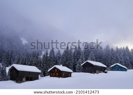 Traditional wooden mountain huts in Gauertal in winter. Montafon, Vorarlberg, Austria.