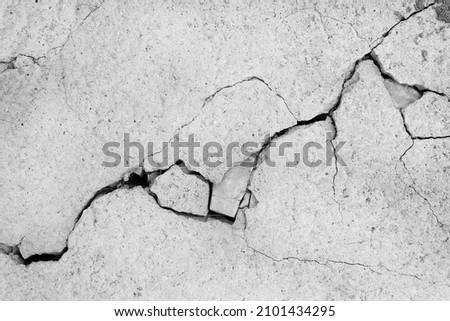 Grey plaster facade house wall with dark cracks Royalty-Free Stock Photo #2101434295