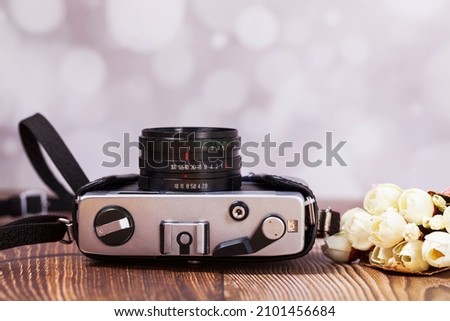 Retro camera on a wooden table, close-up