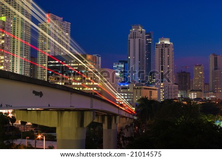 Miami Elevated Commuter Train Tracks and City Buildings at Night