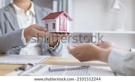 Real estate agents or sales managers hand over homes to customers who have signed home purchases with insurance, Entering into a business agreement to transfer property rights, Selling a house. 