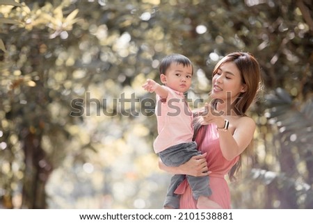 Portrait of asian mother playing with newborn baby, baby talking to mother. Health care family love together. Asian girl lifestyle. Asia mother's day concept