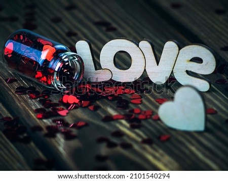 Glass jar with Hearts on Wooden Background, and the Word Love Concept, Valentine's Day 