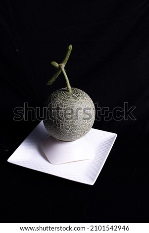 Photo of full organic melon from your own garden with a black background