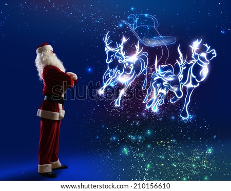 Santa Claus and christmas deers in sled